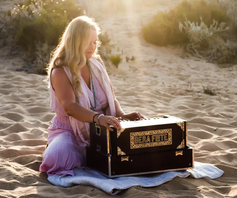 Sharmila Devasya playing traditional healing instruments including bera flute